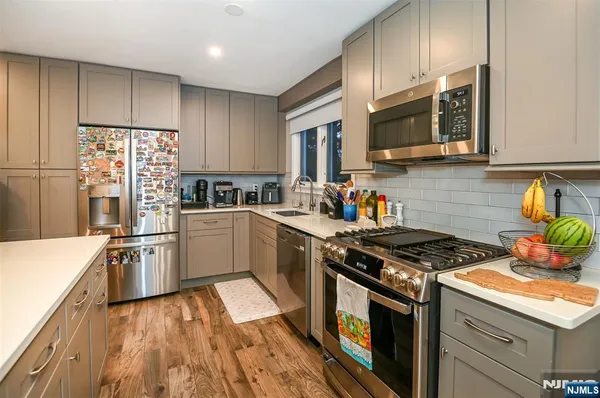 a kitchen with a stove a sink and a microwave