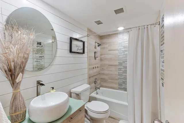 a bathroom with a toilet a sink and bathtub