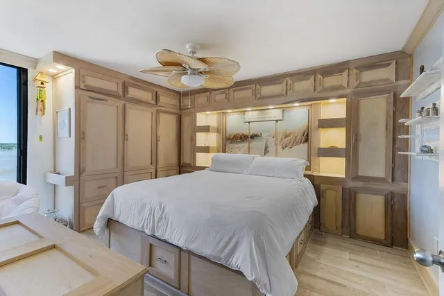 a bedroom with a bed and a large window