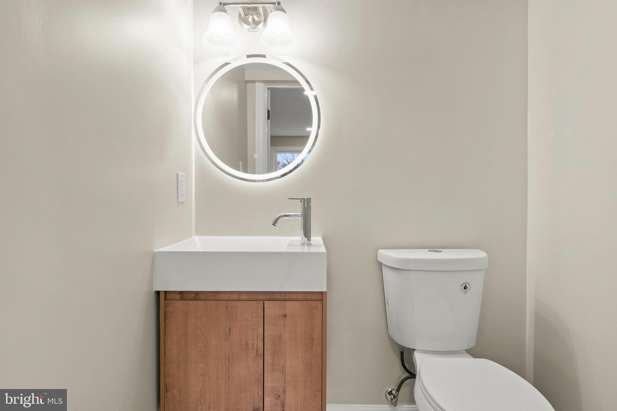 998 Kingston Drive Cherry Hill, NJ 08034 - Photo 11 of 35 a bathroom with a toilet a sink and a mirror