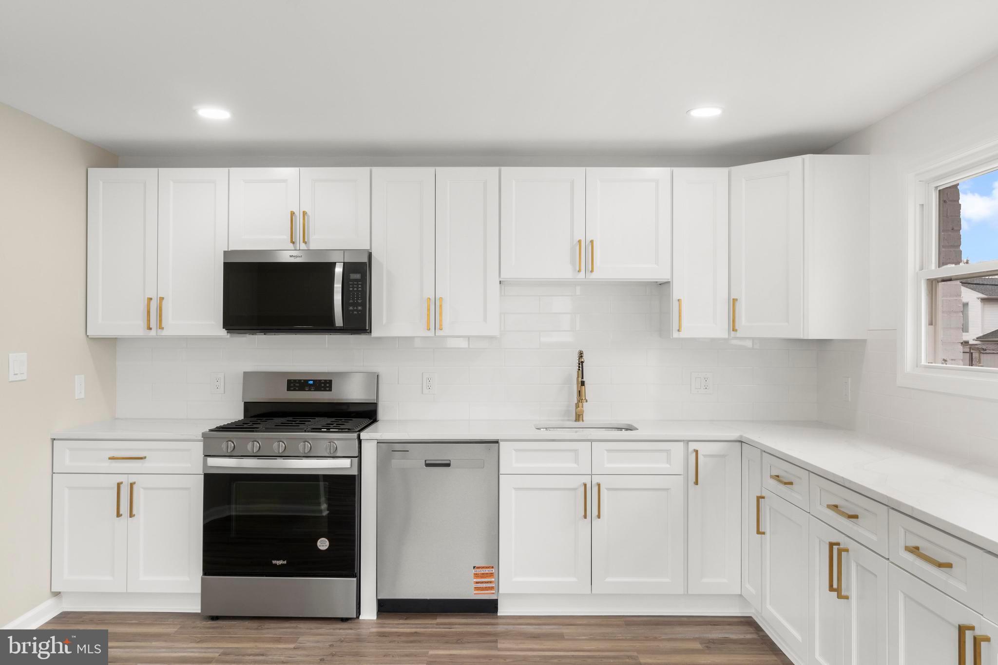 998 Kingston Drive Cherry Hill, NJ 08034 - Photo 16 of 35 a kitchen with white cabinets and stainless steel appliances