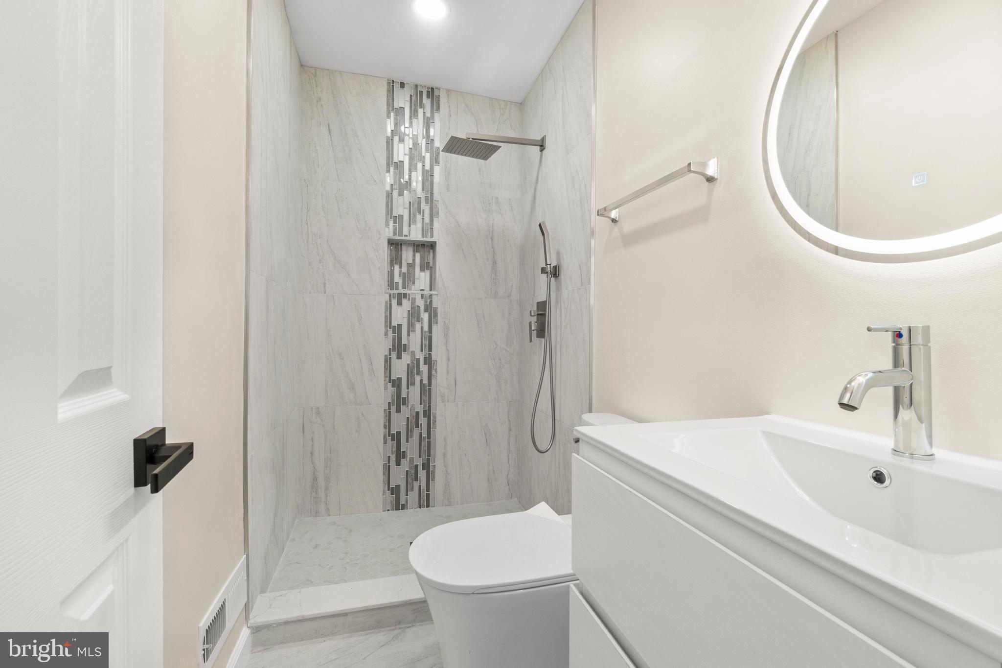 998 Kingston Drive Cherry Hill, NJ 08034 - Photo 24 of 35 a bathroom with a sink a toilet and shower