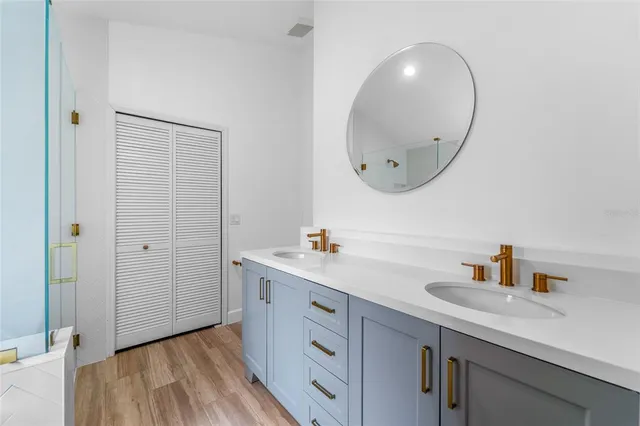 a bathroom with a sink a mirror a vanity and a toilet