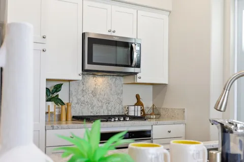 a bathroom with a granite countertop sink a toilet and shower
