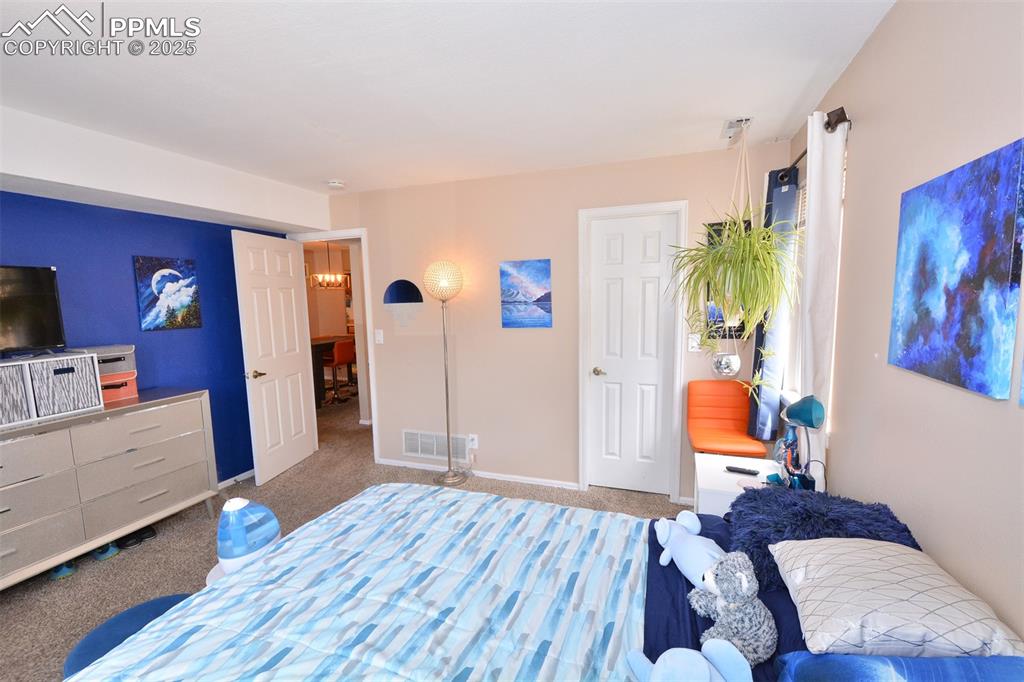 846 Tenderfoot Hill Road, Unit 104 Colorado Springs, CO 80906 - Photo 11 of 13 a bedroom with furniture and a wooden floor