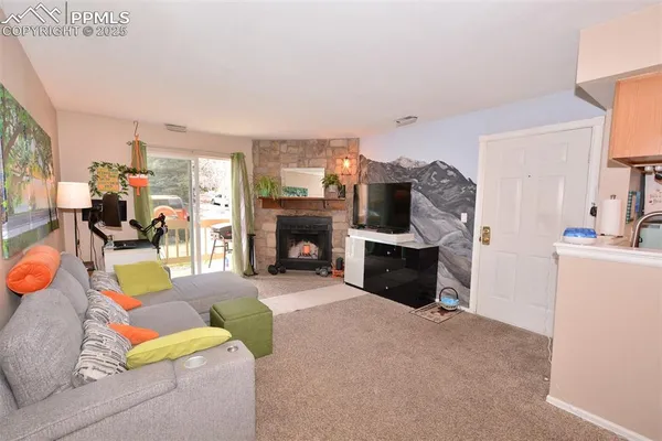 a living room with furniture and a fireplace