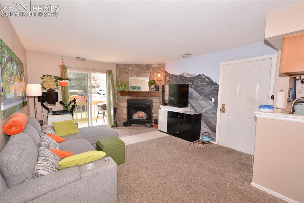 846 Tenderfoot Hill Road, Unit 104 Colorado Springs, CO 80906 - Photo 2 of 13 a living room with furniture and a fireplace