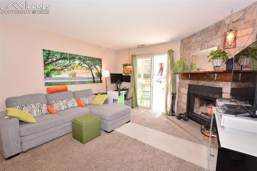846 Tenderfoot Hill Road, Unit 104 Colorado Springs, CO 80906 - Photo 3 of 13 a spacious bedroom with a bed and a couch