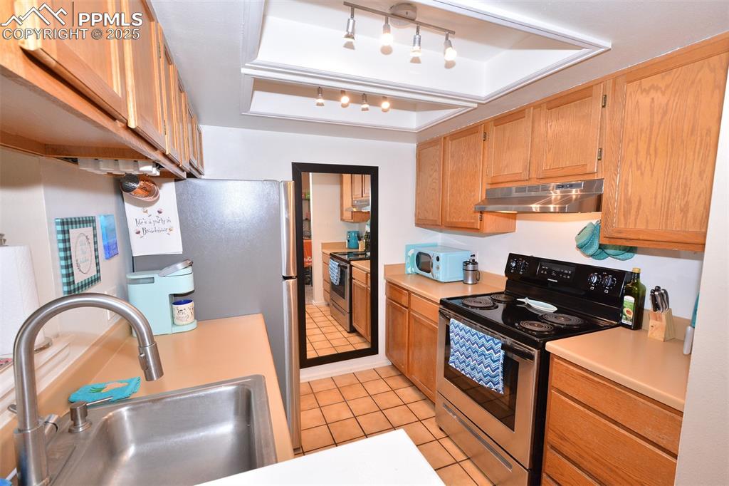 846 Tenderfoot Hill Road, Unit 104 Colorado Springs, CO 80906 - Photo 8 of 13 a kitchen with stainless steel appliances granite countertop a refrigerator and a stove top oven