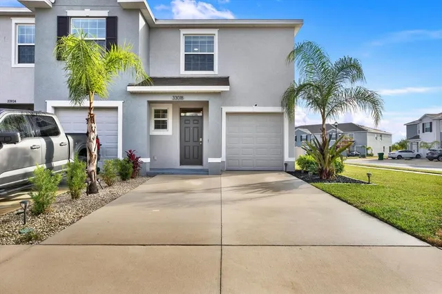a view of a house with a yard and plants