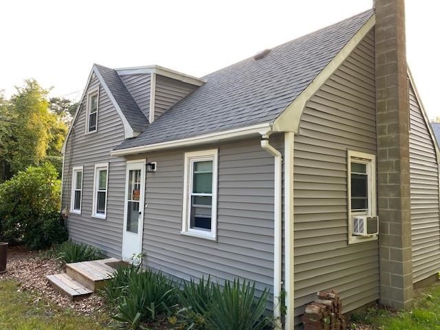 a view of a house with a yard and plants