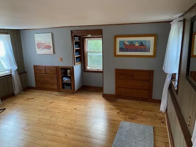 a view of an empty room with furniture and a fireplace
