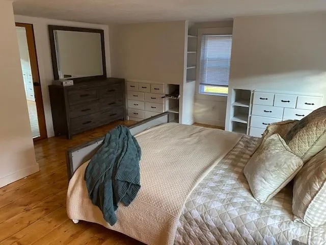 a bedroom with a bed and cabinet