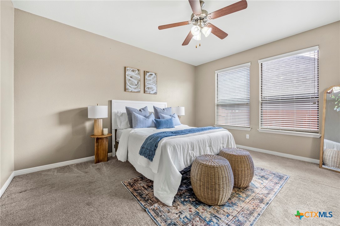 3306 Castleton Drive Killeen, TX 76542 - Photo 17 of 39 a bedroom with a bed and a chandelier