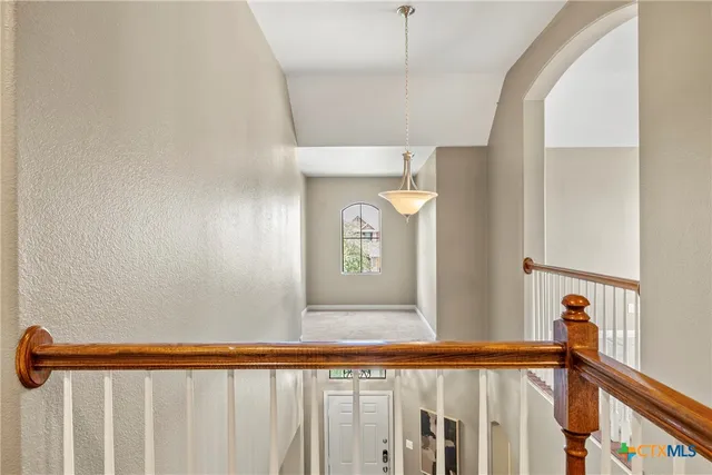 an empty room with windows and ceiling fan