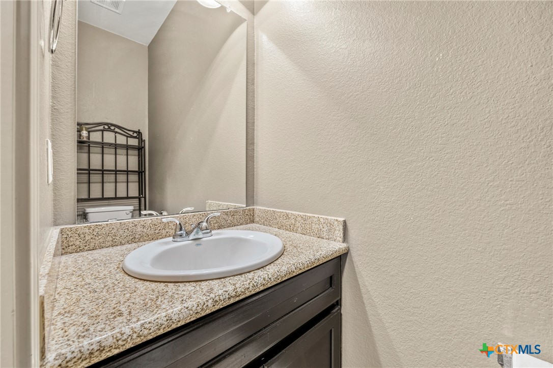 3306 Castleton Drive Killeen, TX 76542 - Photo 25 of 39 a bathroom with a granite countertop sink and a mirror