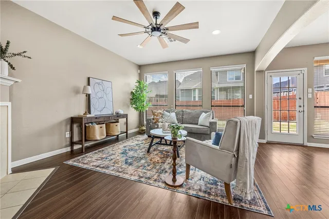 a kitchen with stainless steel appliances wooden floor sink stove and cabinets