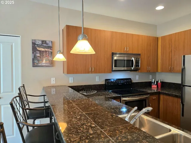 a kitchen with a stove a sink and a microwave
