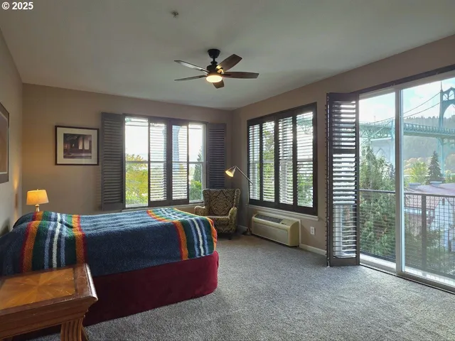 a bedroom with furniture and large windows