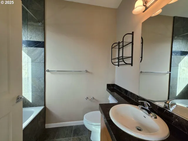 a bathroom with a sink toilet and a mirror