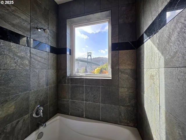 a bathroom with a bathtub and shower