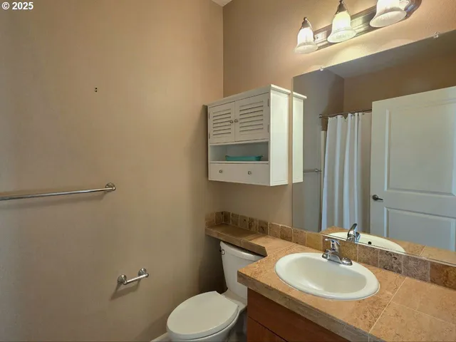 a bathroom with a sink toilet and mirror