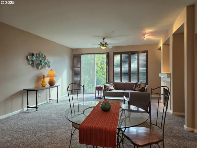 a living room with furniture and floor to ceiling windows