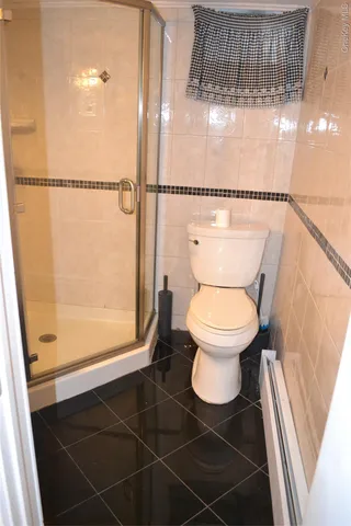 a bathroom with a toilet and a shower