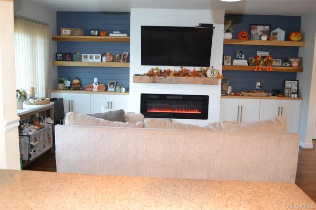 a living room with hard wood floors and a fireplace