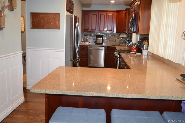 a kitchen with kitchen island a sink a stove and a refrigerator