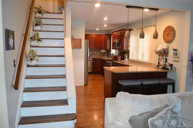 a view of entryway and hall with wooden floor