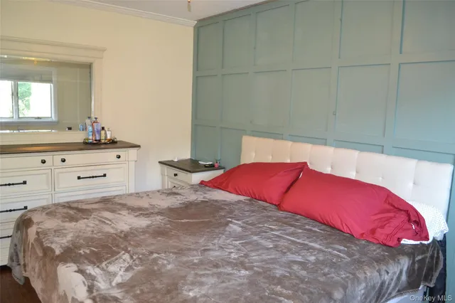 a bedroom with a large bed and a dresser