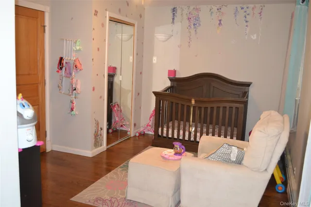 a bedroom with furniture and a wooden floor