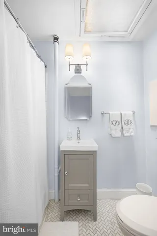a bathroom with a sink a toilet and mirror