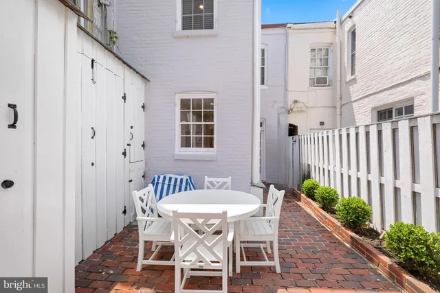 a view of a patio with table and chairs and wooden floor