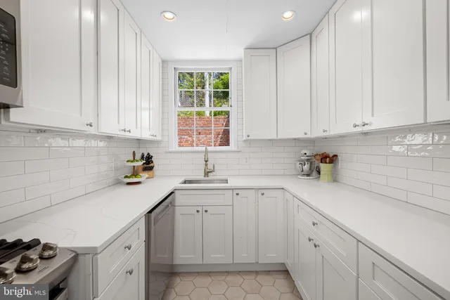 a kitchen with a sink window and cabinets