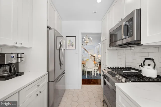 a kitchen with stainless steel appliances granite countertop a sink and a stove