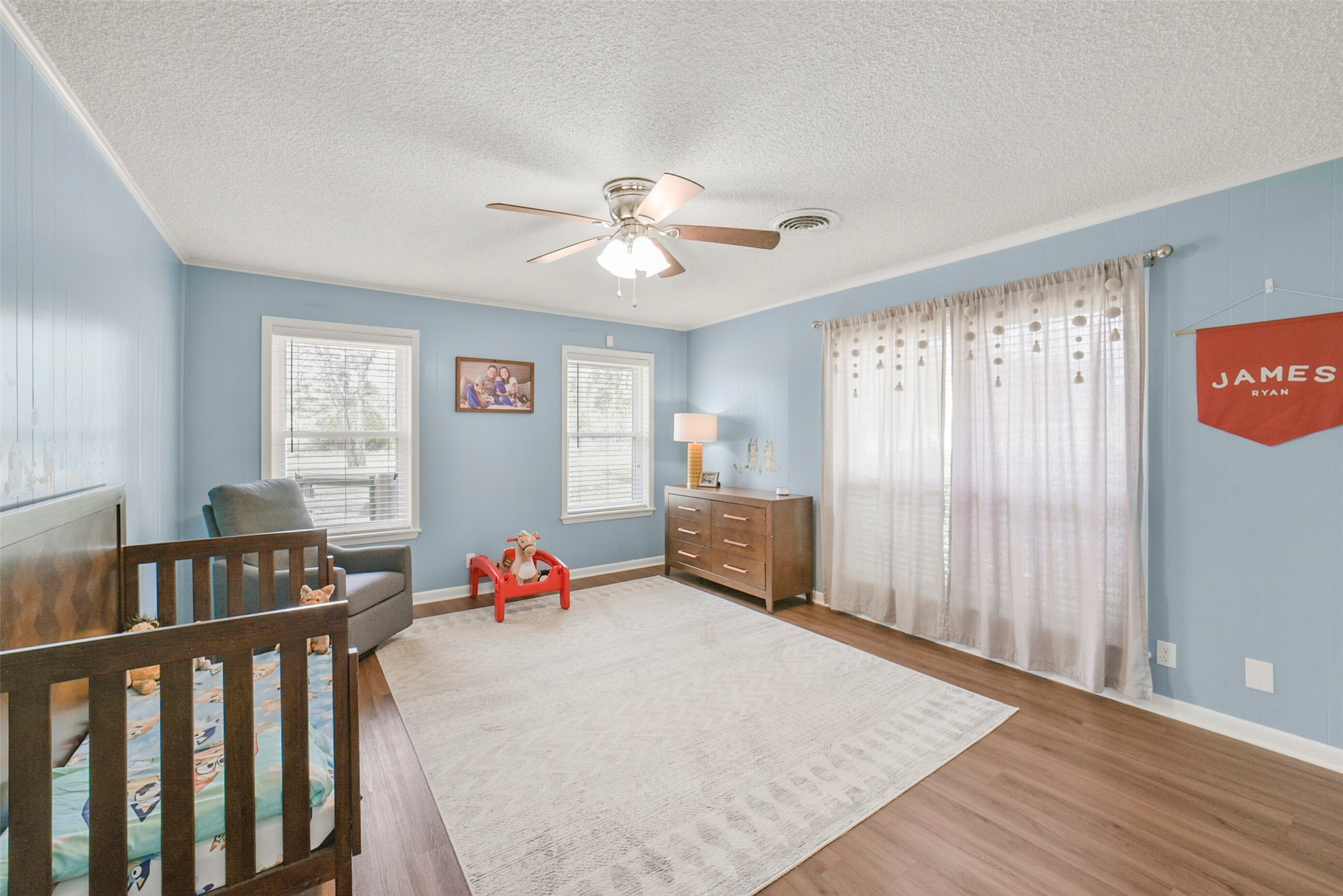 10313 South Williams Road Conroe, TX 77303 - Photo 28 of 48 Bedroom #2 with ceiling fan, vinyl plank flooring, and large windows.