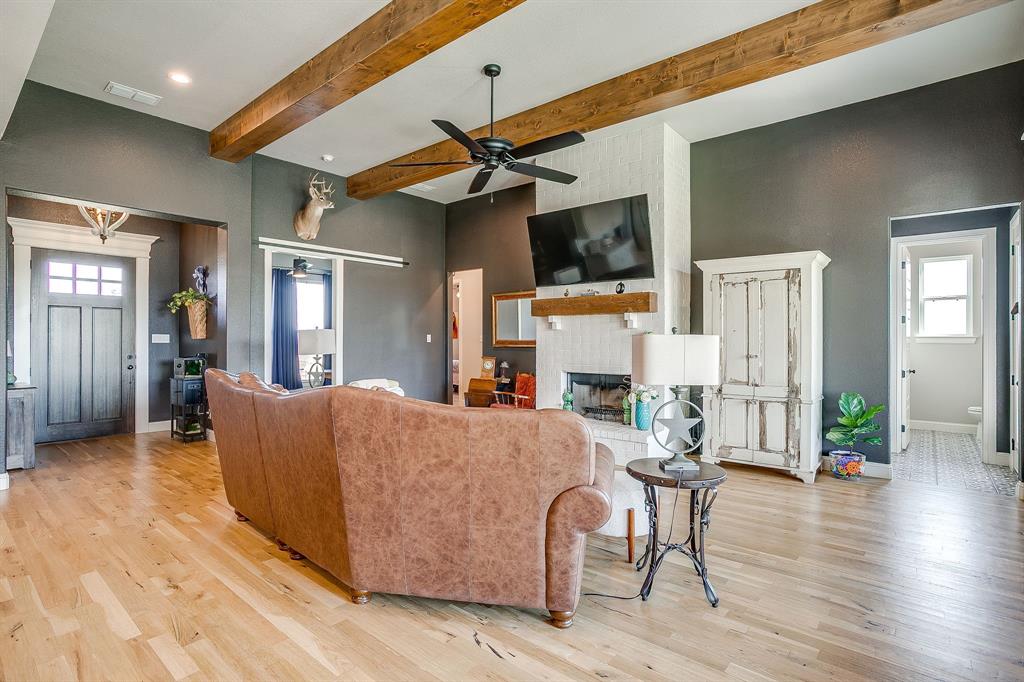 116 Aviara Ridge Road Poolville, TX 76487 - Photo 13 of 38 a living room with furniture and a fireplace