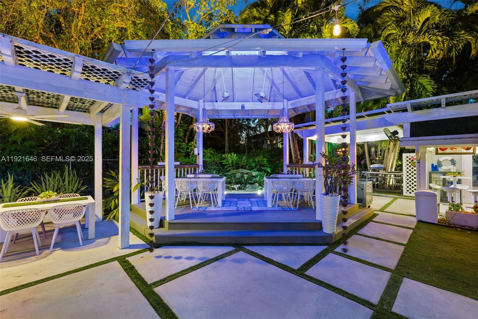 7720 Southwest 79th Court Miami, FL 33143 - Photo 21 of 58 a view of a patio with a table and chairs under an umbrella