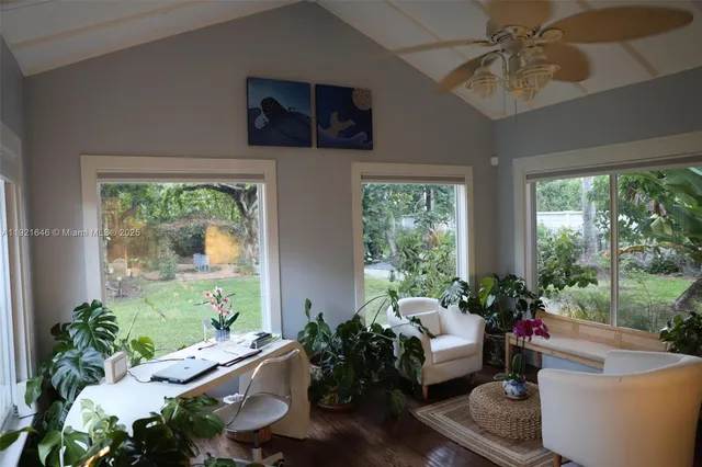 a living room with furniture a chandelier and a large window