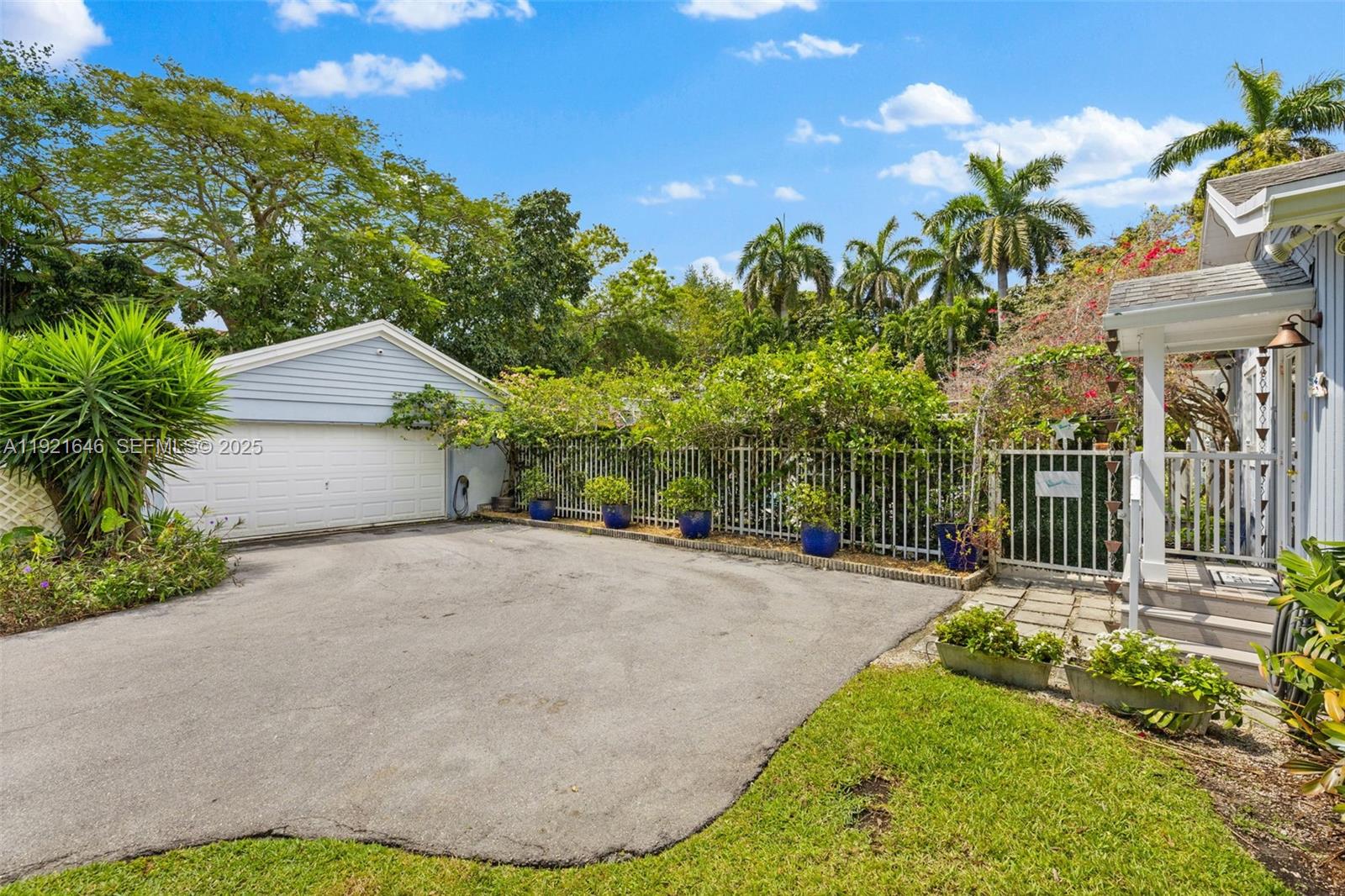 7720 Southwest 79th Court Miami, FL 33143 - Photo 4 of 58 a house view with a garden space