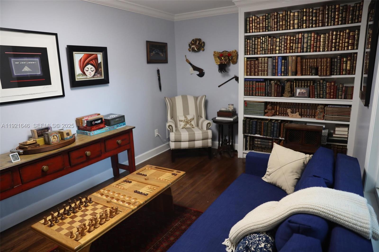 7720 Southwest 79th Court Miami, FL 33143 - Photo 41 of 58 a living room with furniture and book shelf