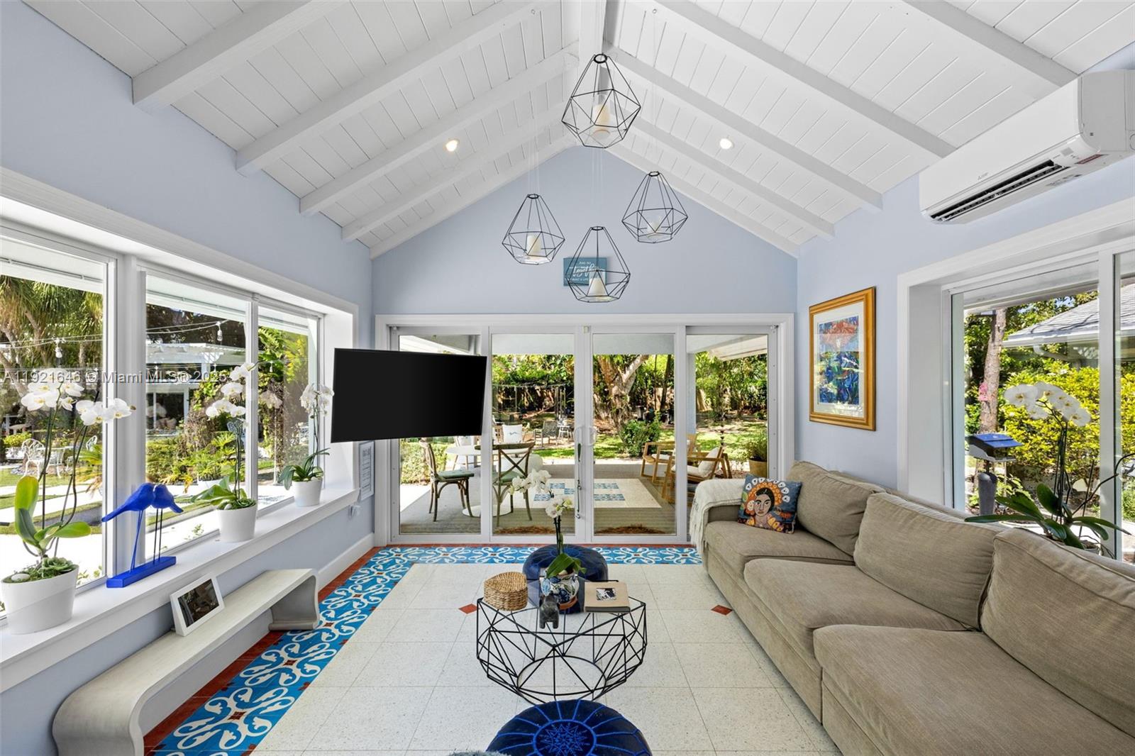 7720 Southwest 79th Court Miami, FL 33143 - Photo 44 of 58 a living room with furniture a flat screen tv and a large window