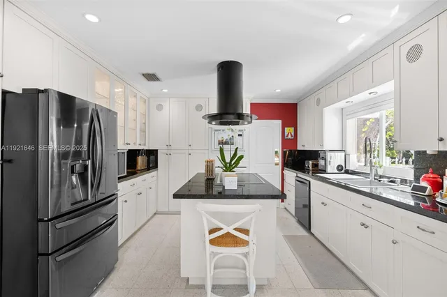 a white toilet sitting next to a bathroom sink