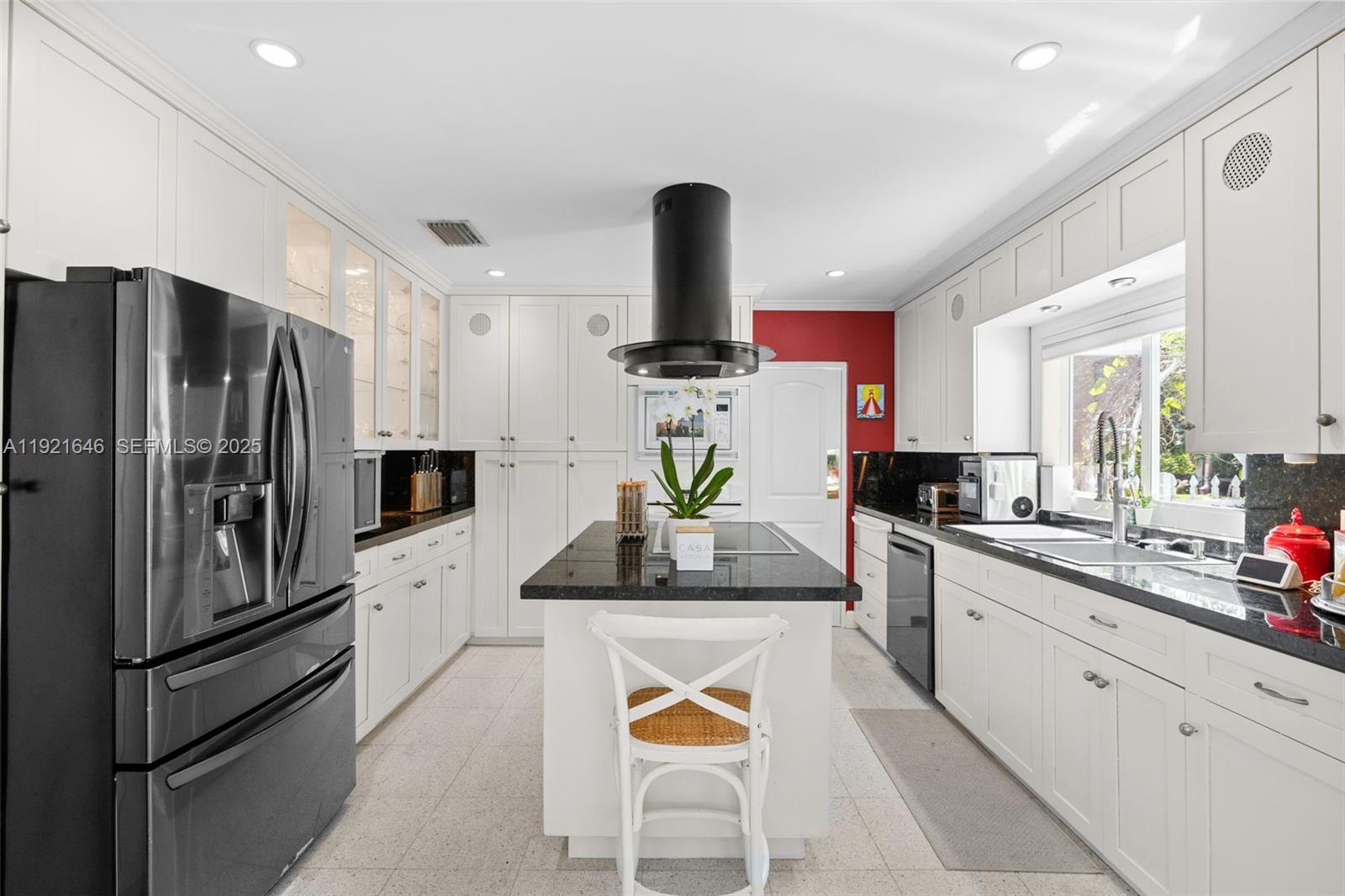 7720 Southwest 79th Court Miami, FL 33143 - Photo 47 of 58 a kitchen with stainless steel appliances kitchen island granite countertop a refrigerator a stove and a sink