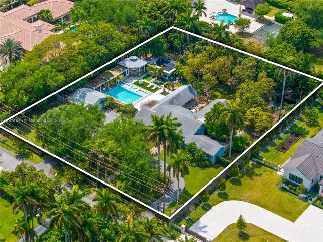 a living room with patio furniture and a potted plant