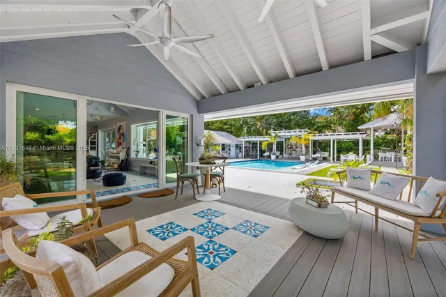 a view of a swimming pool with sitting area and a yard