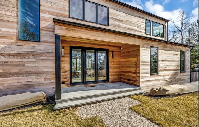 a view of a house with swimming pool and a porch