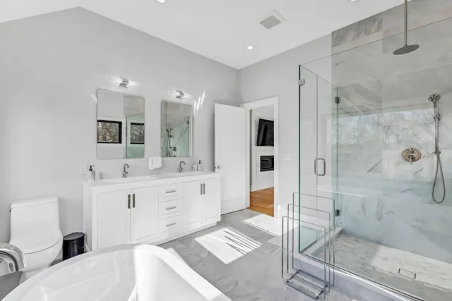 a spacious bathroom with a bathtub and sink